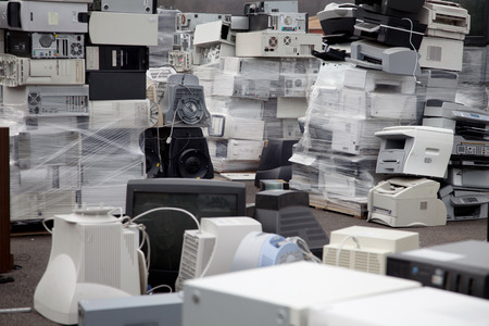 Stacks of electronic equipment, printers and computers in a recycling center