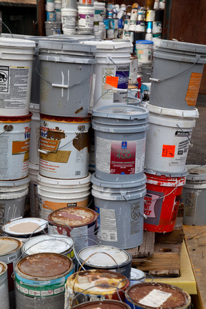 Fairfax, VA, USA - December 5, 2013: Paint cans gathered in order to be recycled. They will be sorted out and the latex ones will be separated from the oil cans. Unlike oil paints, latex paints aren't considered hazardous waste and can be recycled with meのeditorial素材