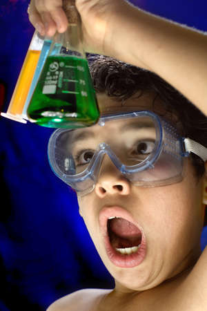 a child amazed watching a chemical experiment in test tubes