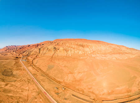 The Flaming Mountains are barren eroded red sandstone hills in Tian Shan Mountain range Xinjiang China.の写真素材