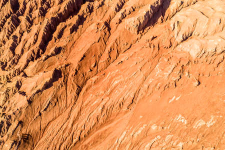 The Flaming Mountains are barren eroded red sandstone hills in Tian Shan Mountain range Xinjiang China.の写真素材