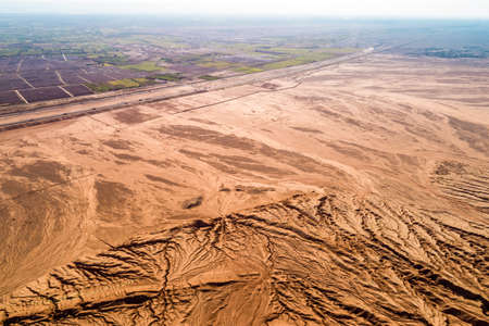 The Flaming Mountains are barren eroded red sandstone hills in Tian Shan Mountain range Xinjiang China.の写真素材