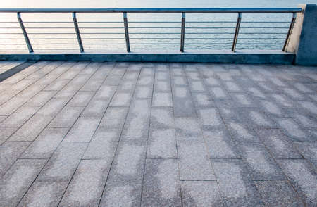 Terrace of a modern building with the sea in the backgroundの写真素材