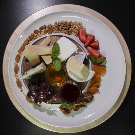 Cheese plate.Isolated on a black background.View from above.