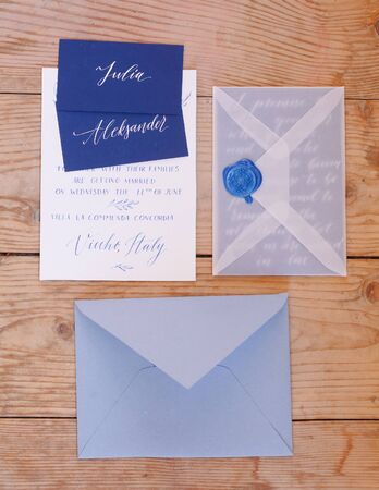 Wedding details flat lay on wooden background. Wedding invitation. Wedding bouquet. Copy space. Mock up. Envelope.の写真素材