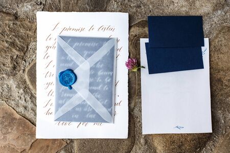 Wedding details flat lay on stone background. Wedding invitation. Ring box. Copyspace. Mock up.の写真素材