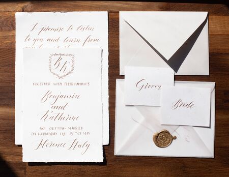 Wedding details flat lay on wooden background. Wedding invitation. Wedding bouquet. Copy space. Mock up. Envelope.の写真素材