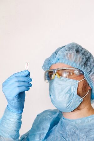 Close up of doctor hand holding vaccine. Medical equipment. A doctor wearing personal protective...