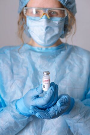 Coronavirus vaccine. Doctor with a vaccine. Nurse holding a coronavirus vaccine. Hands holding a...