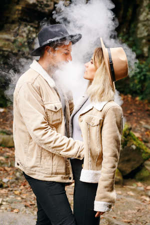 A beautiful girl and a handsome man in military truck. Lovestory. Military vehicle. Military fashion.Carpathian mountains.の写真素材