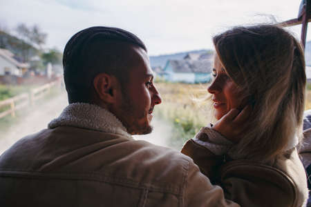 Couple in vape cloud. Two in smoke. Tourists in cold autumn forest with vape. Man and women in smoke. Two smokers. Beautiful couple in fog. E-cigarettes and peopleの写真素材