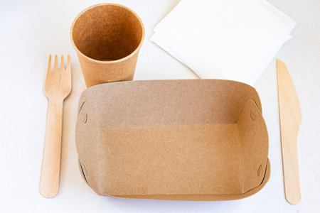 Disposable environmentally eco-friendly food packaging. Brown craft paper containers, drink glasses, forks and knifes. Mockup, template.の写真素材