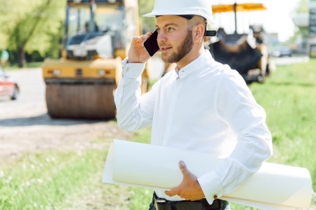 Civil engineering, road construction. The concept of building a new asphalt road. road repair. Road service worker near the market.の写真素材