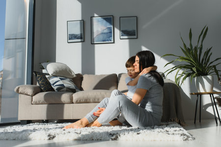 Closeup of happy family playing over the bed in a relaxed morning. Weekend family leisure time concept.の写真素材