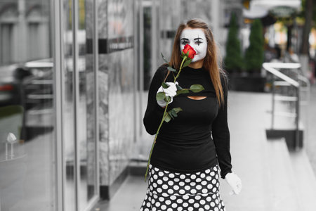 woman mime with red roseの写真素材