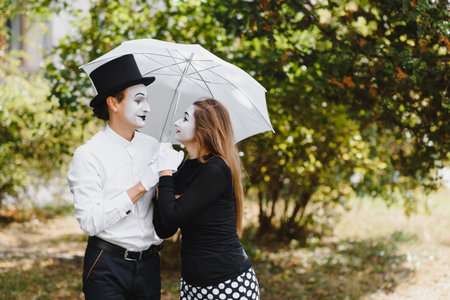A couple of merry mimes. He hurries on a date.の写真素材