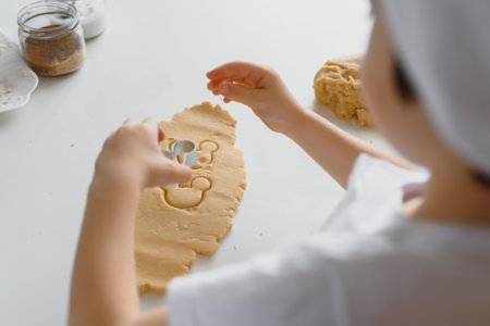 Happy family in the kitchen. Mother and son preparing cookies.の写真素材