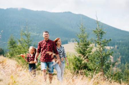 Young family with child resting on a mountain. vacation in the national park.の写真素材