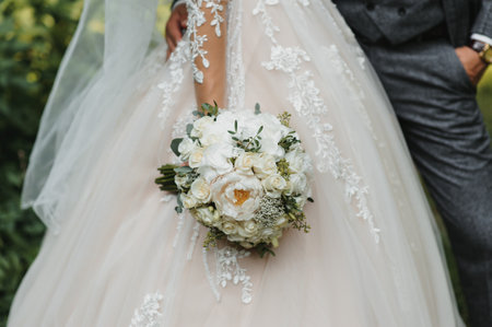 Bride holding big wedding bouquet on wedding ceremonyの写真素材