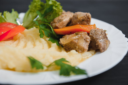 mashed potatoes with meat and vegetables on wooden backgroundの写真素材