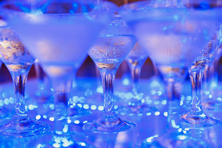 Champagne glasses standing in a tower at the partyの写真素材