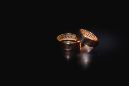 Beautiful wedding gold rings on dark background