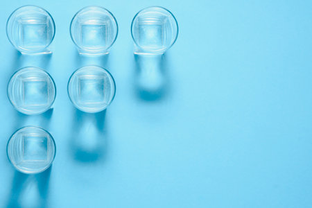 water filters. Carbon cartridges and glasses on a blue background. Household filtration system.の写真素材