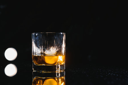 Whiskey glass black background shinyの写真素材