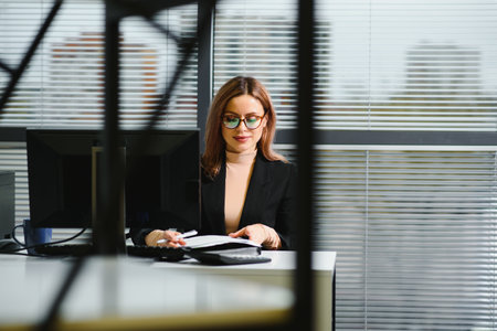 portrait of successful female sitting in officeの写真素材