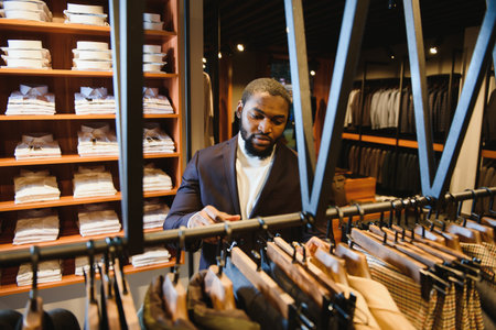 A stylish elegantly dressed African-American man working at classic menswear store.の写真素材
