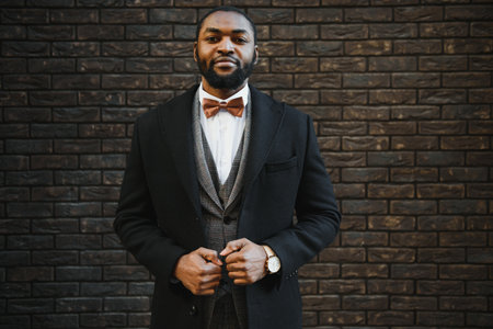 Portrait of an African American businessman wearing a suit standing in an outdoor business environmentの写真素材