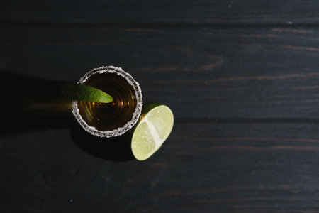 Mexican Gold Tequila with lime and salt on black background with copyspace.の写真素材