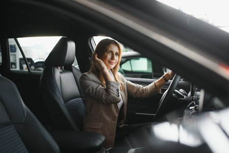beautiful woman sitting at the wheel of a carの写真素材