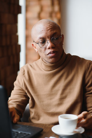 African american business man with laptop in a cafeの写真素材