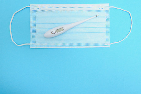 Surgical mask with rubber ear straps. Typical 3-ply surgical mask to cover the mouth and nose. Procedure mask from bacteria. protection concept.の写真素材
