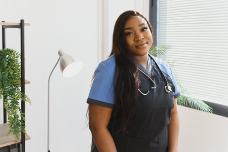 Young beautiful African American girl doctor in a white coat with a stethoscope