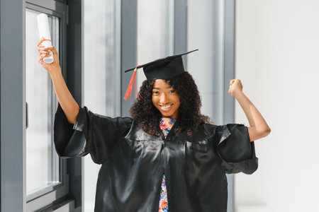 cheerful african american graduate student with diploma in her handの写真素材
