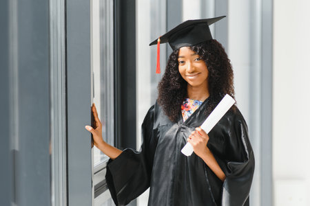 cheerful african american graduate student with diploma in her handの写真素材