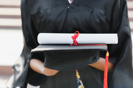 graduating student holding her diploma. close up