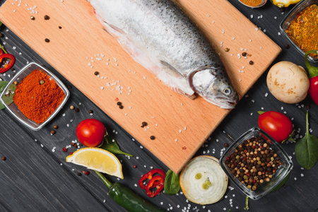 fresh trout with spices and seasonings top view, flat layの写真素材