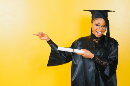 cheerful african american graduate student with diploma in her handの写真素材