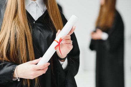 portrait of multiracial graduates holding diplomaの写真素材