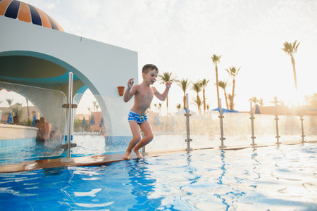 Boy jumping in swimming poolの写真素材