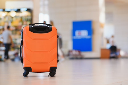 Large suitcase standing on the floor in modern airport terminal. copy spaceの写真素材