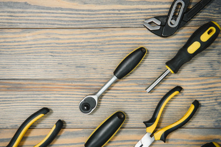 Various tools on wooden background