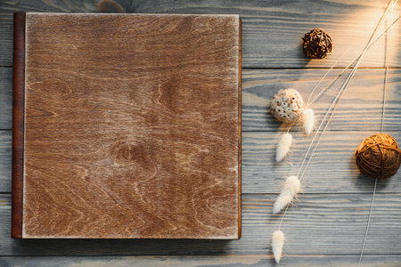 Luxury wooden photo book on natural background. family memories photobook. Save your summer vacation memories. Photo album wedding photo album with wooden cover.の写真素材