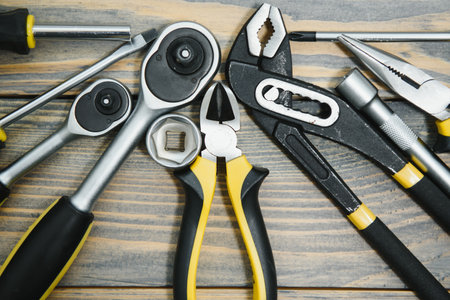 Set of tools over a wood panel with space for text