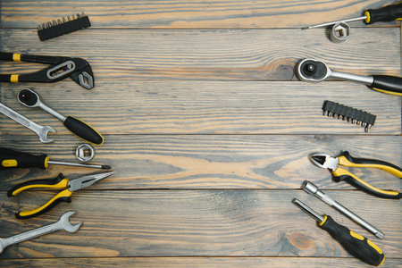 Different tools on a wooden background.