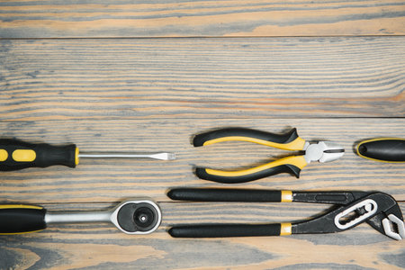 Set of tools over a wood panel with space for text