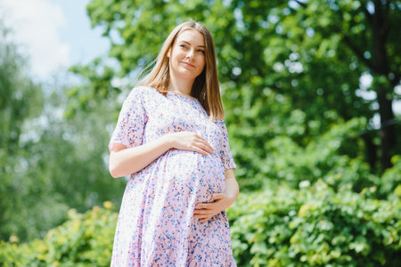 Pregnant woman resting in the parkの写真素材